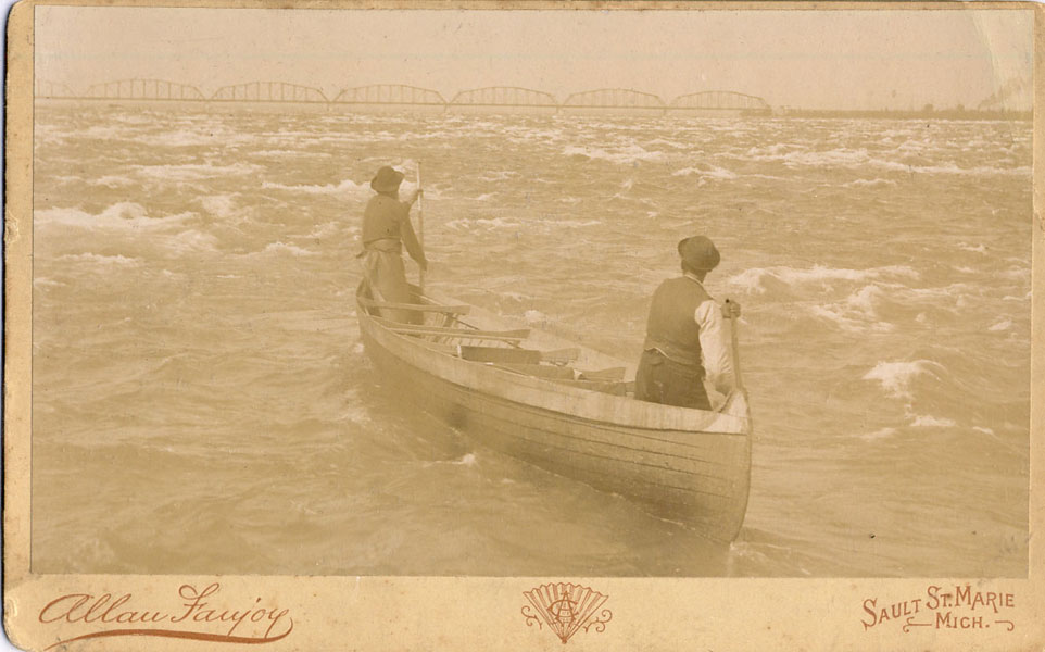 Commercial Cabinet Photograph Of Two Men In A Rapids Canoe On The Saint Marys River, With The Sault Ste. Marie Railroad Bridge In The Background FANJOY, ALLAN [PHOTOGRAPHER]