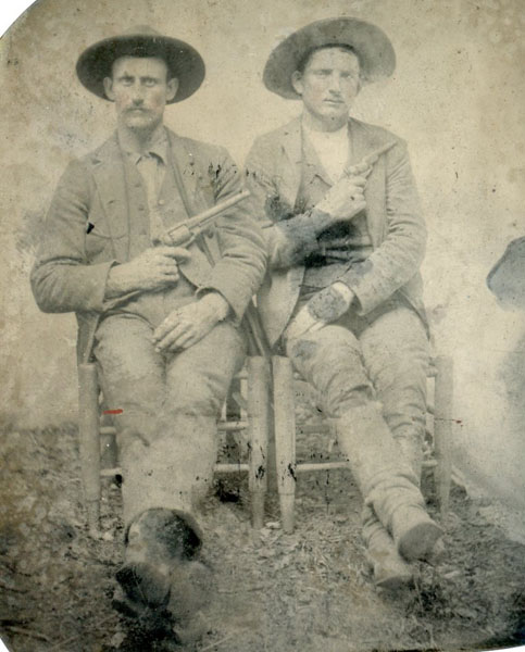 Photograph - Cowboys. Seated Full-Length Portrait Of Two Armed Cowboys With Weapons Drawn PHOTOGRAPHER UNKNOWN